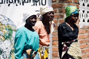 three women standing near wall