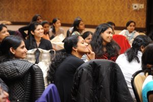 group of women sitting on chair while listening